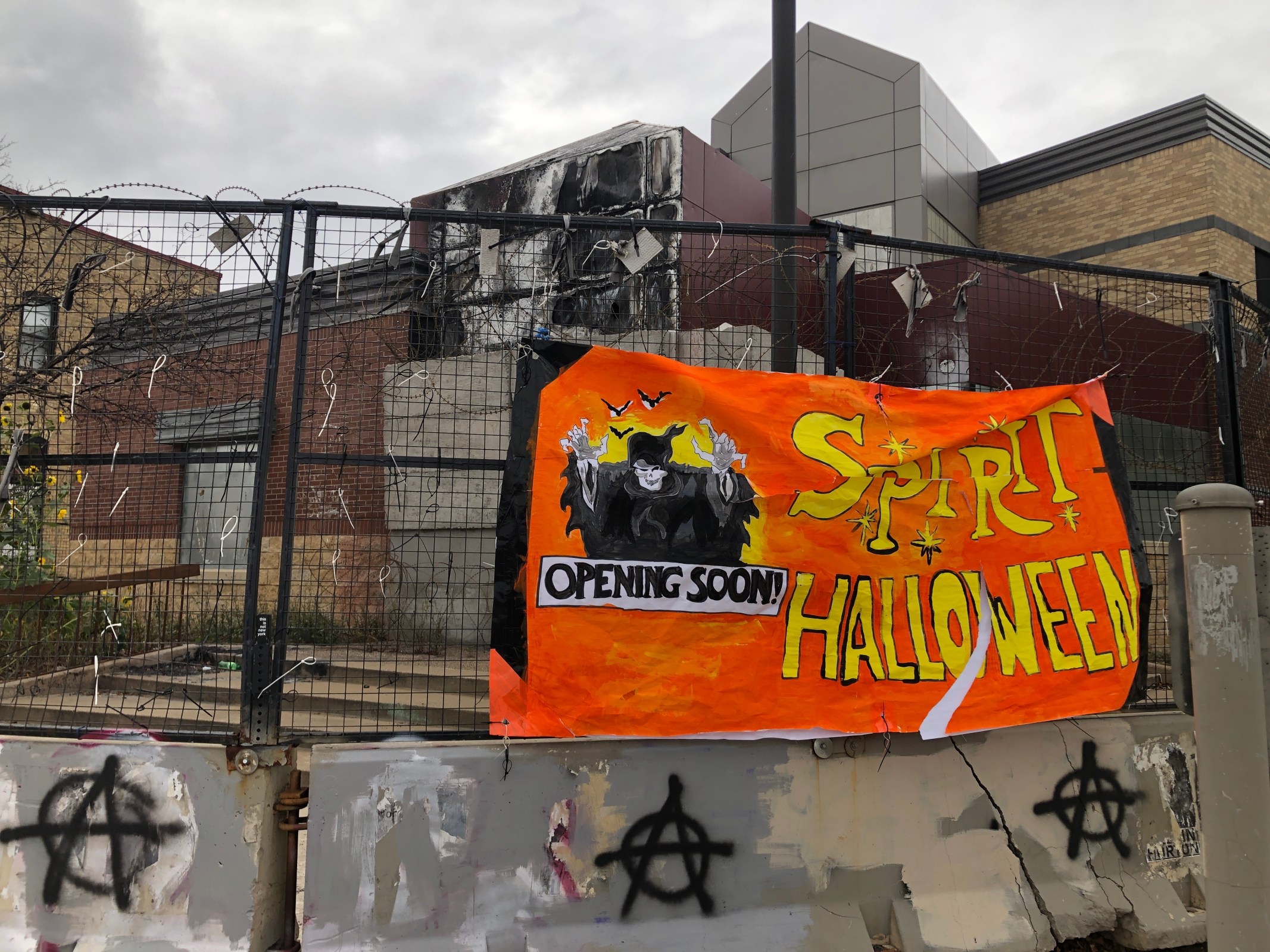 a handmade spirit halloween banner hangs outside the burnt up 3rd precinct