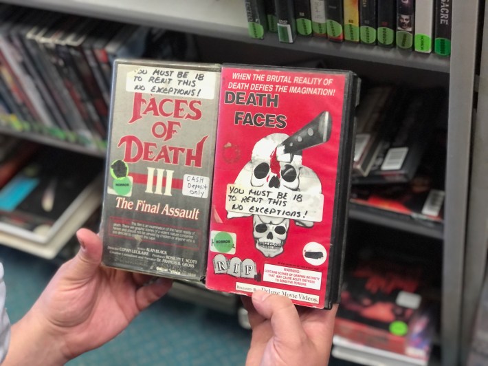 two vhs tapes side by side, both with "you must be 18 to rent this" stickers on them