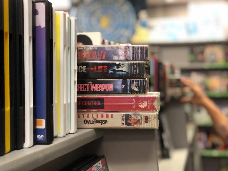 five VHS tapes stacked on a store shelf