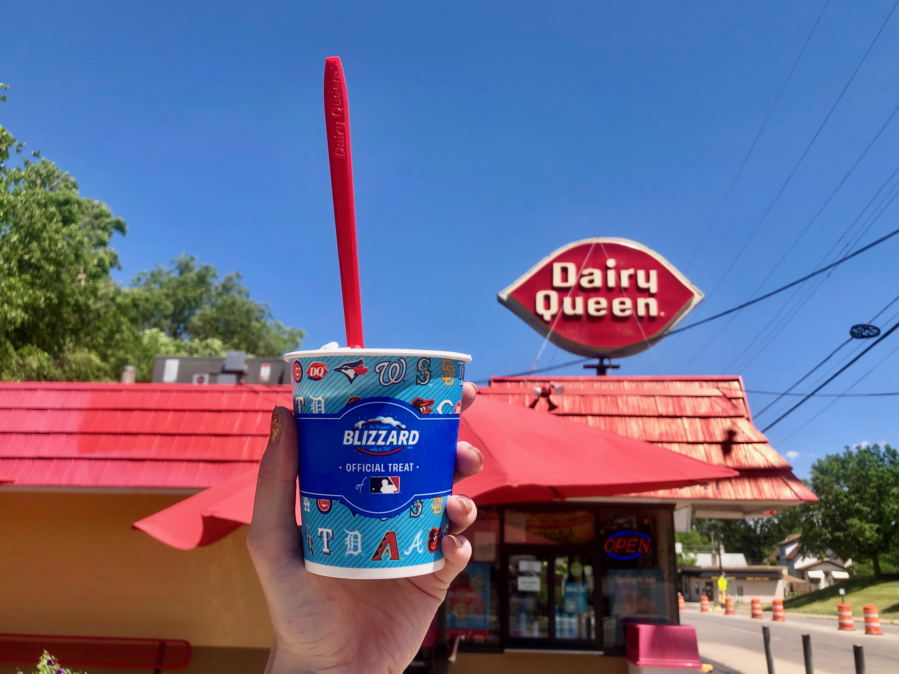 A Blizzard in an MLB cup hoisted high in the air next to the Dairy Queen sign