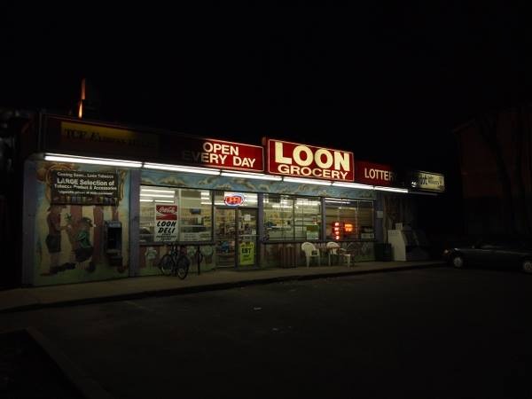 an exterior shot of the loon deli sign at night
