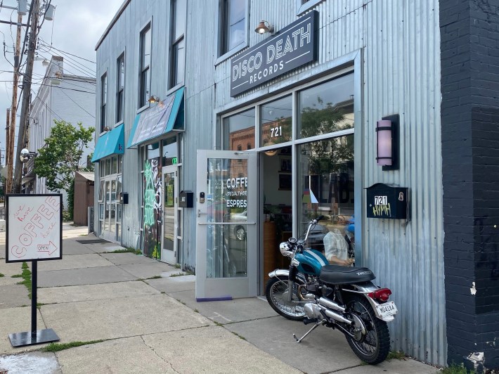 disco death's silver, metal exterior (with a little motor bike parked out front and a sign reading "coffee here!")