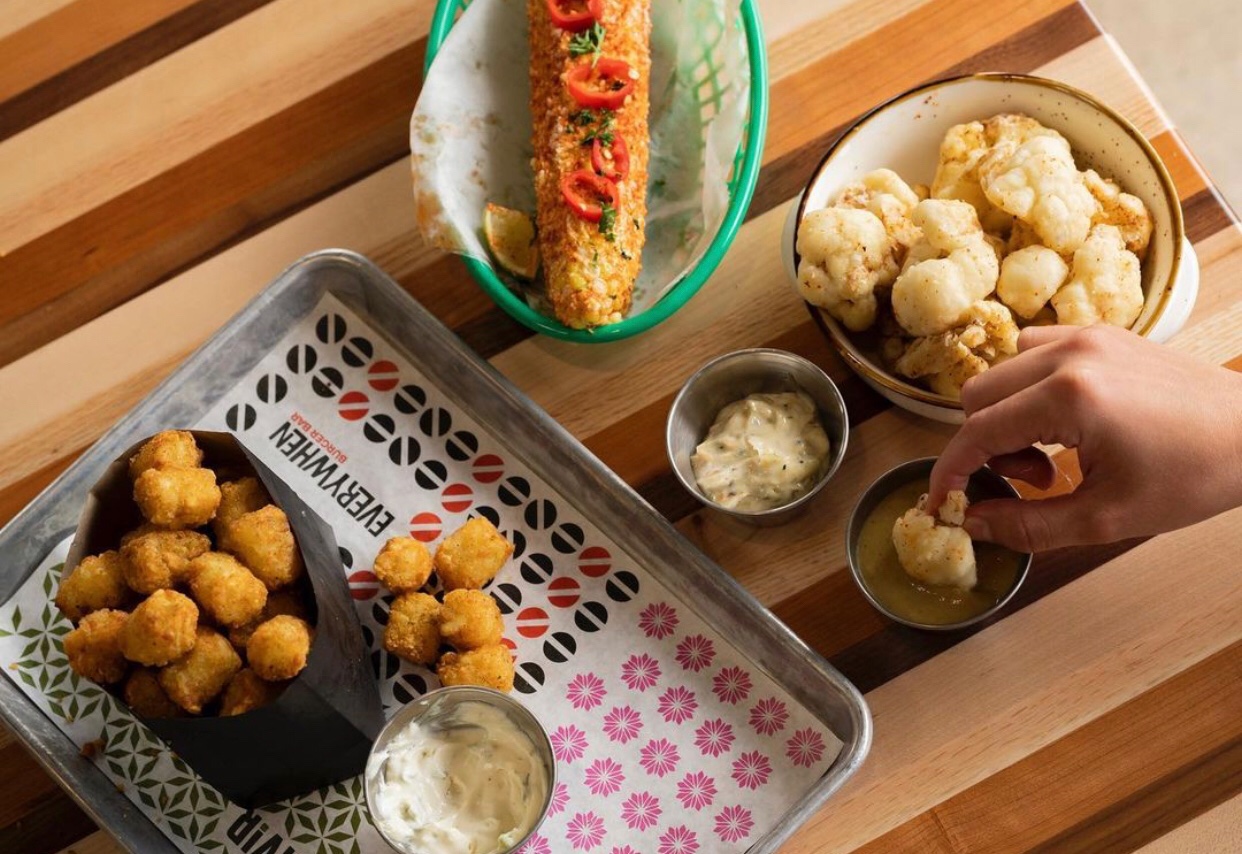 overhead shot of corn, cauliflower bites, and other food items