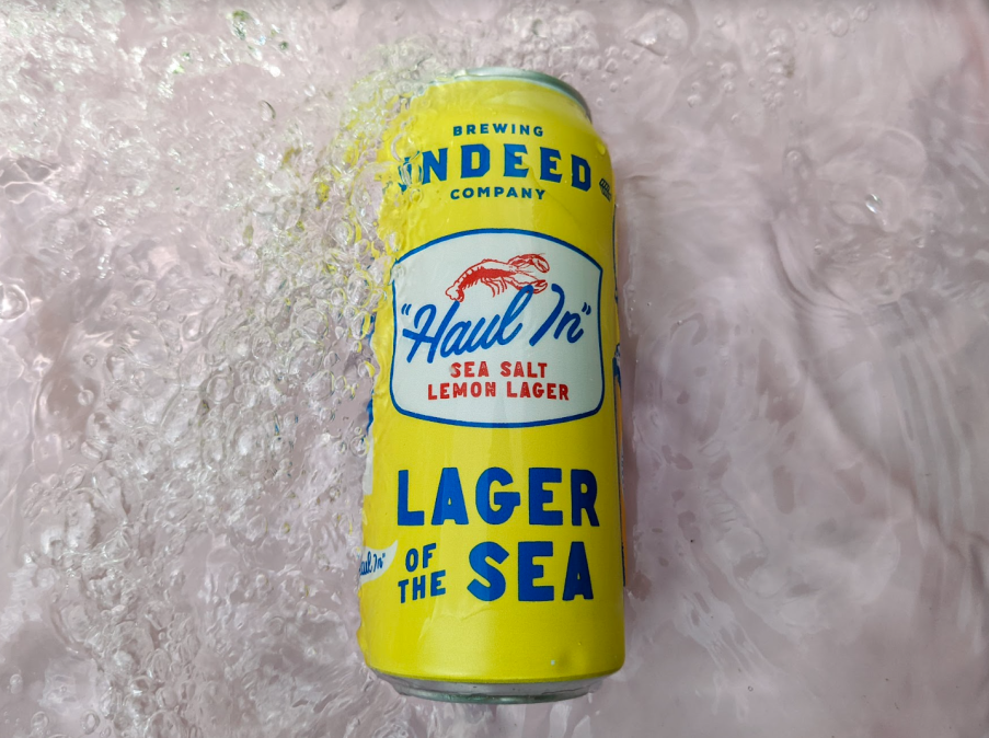 haul in's yellow and blue can in a pool of water