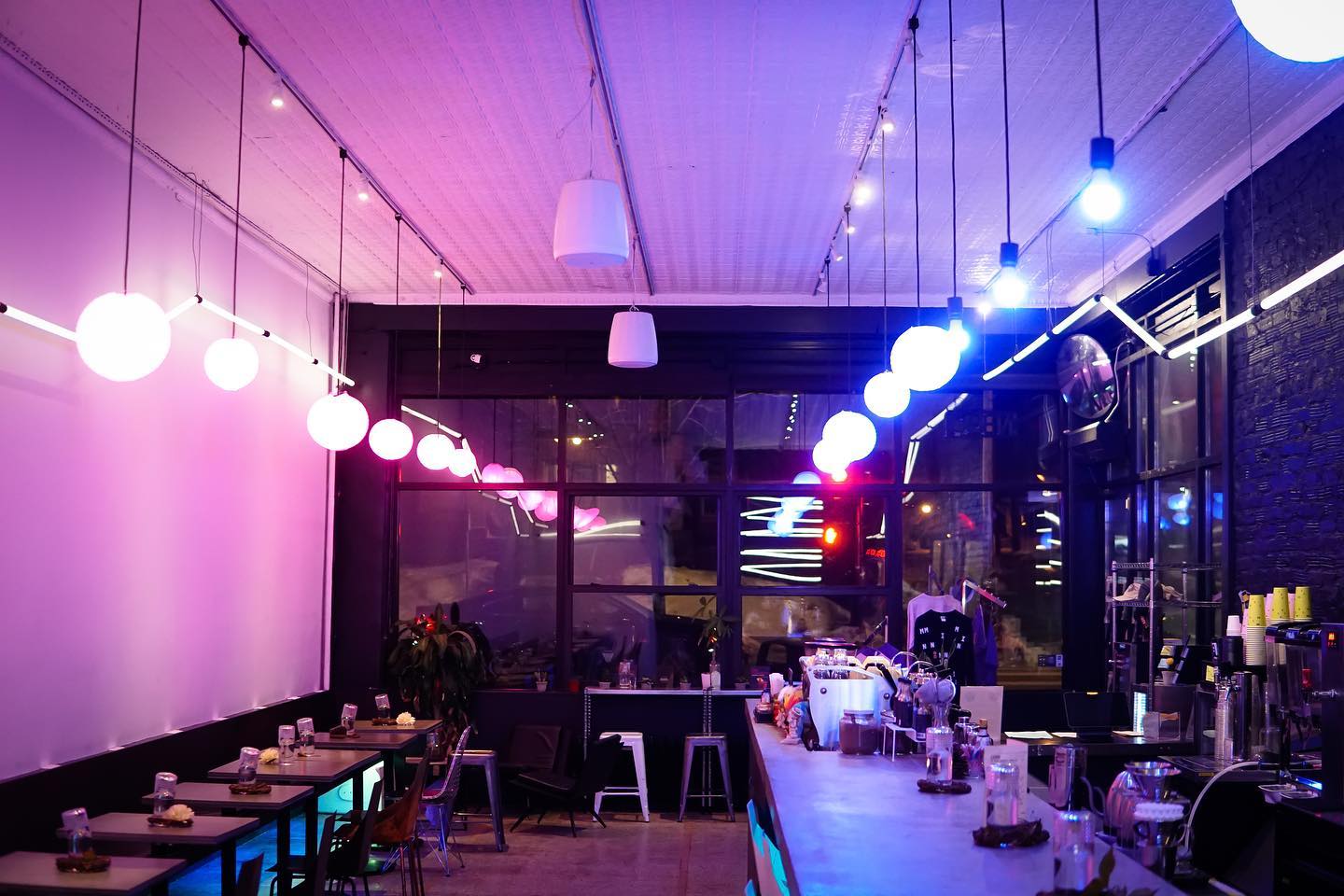 the interior of misfit's coffee shop, which is lit by purple and blue bulbs