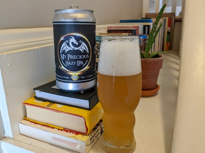 a beer stands on a stack of books