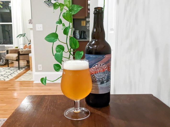 a beer glass and beer on a wooden table