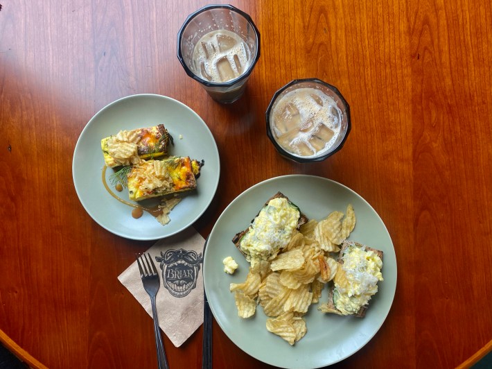 An overhead shot of two plates and two iced coffees at The Briar