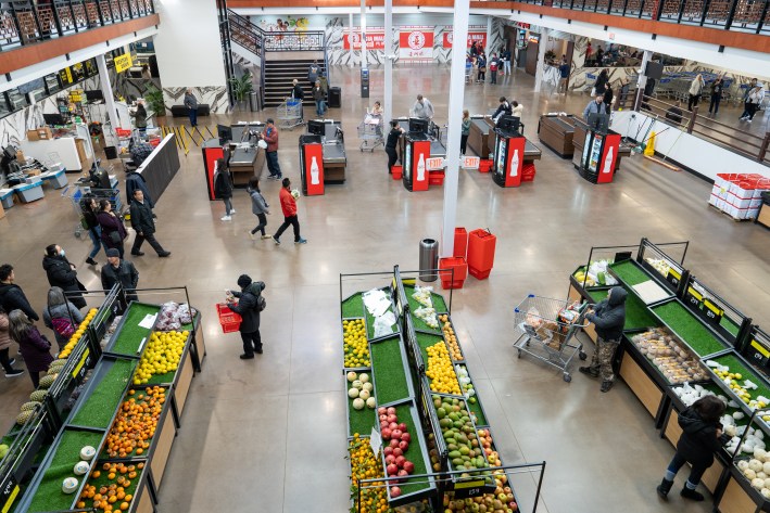 an overhead view of the checkout counters and produce displays at asia mall