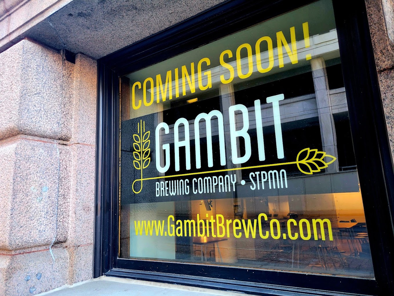 An exterior shot of the windows of Gambit, which have a big "coming soon" decal on them.