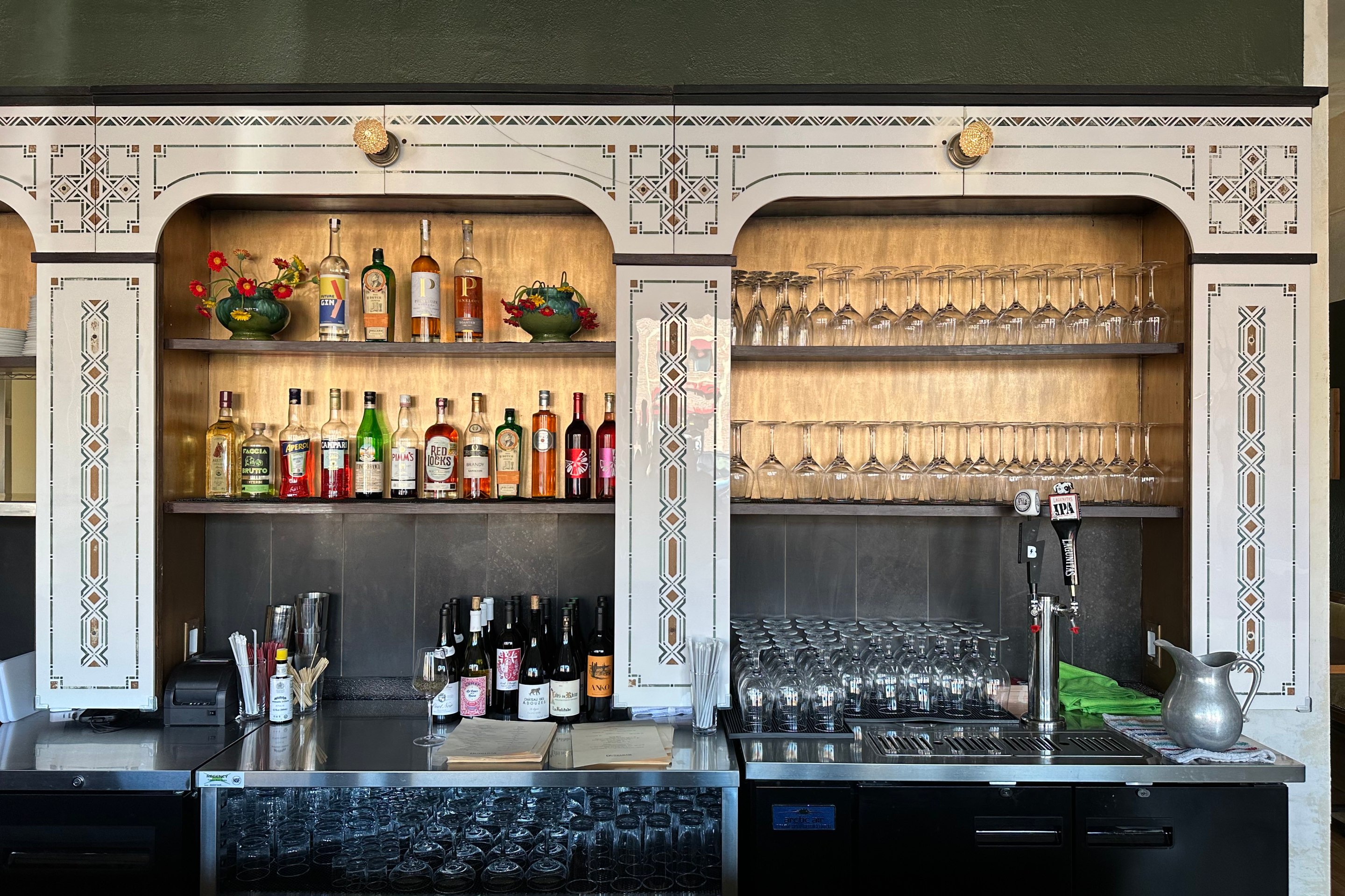The back bar of Dutch Bar, which is reclaimed etched glass from a barbershop that was painted at in 1902